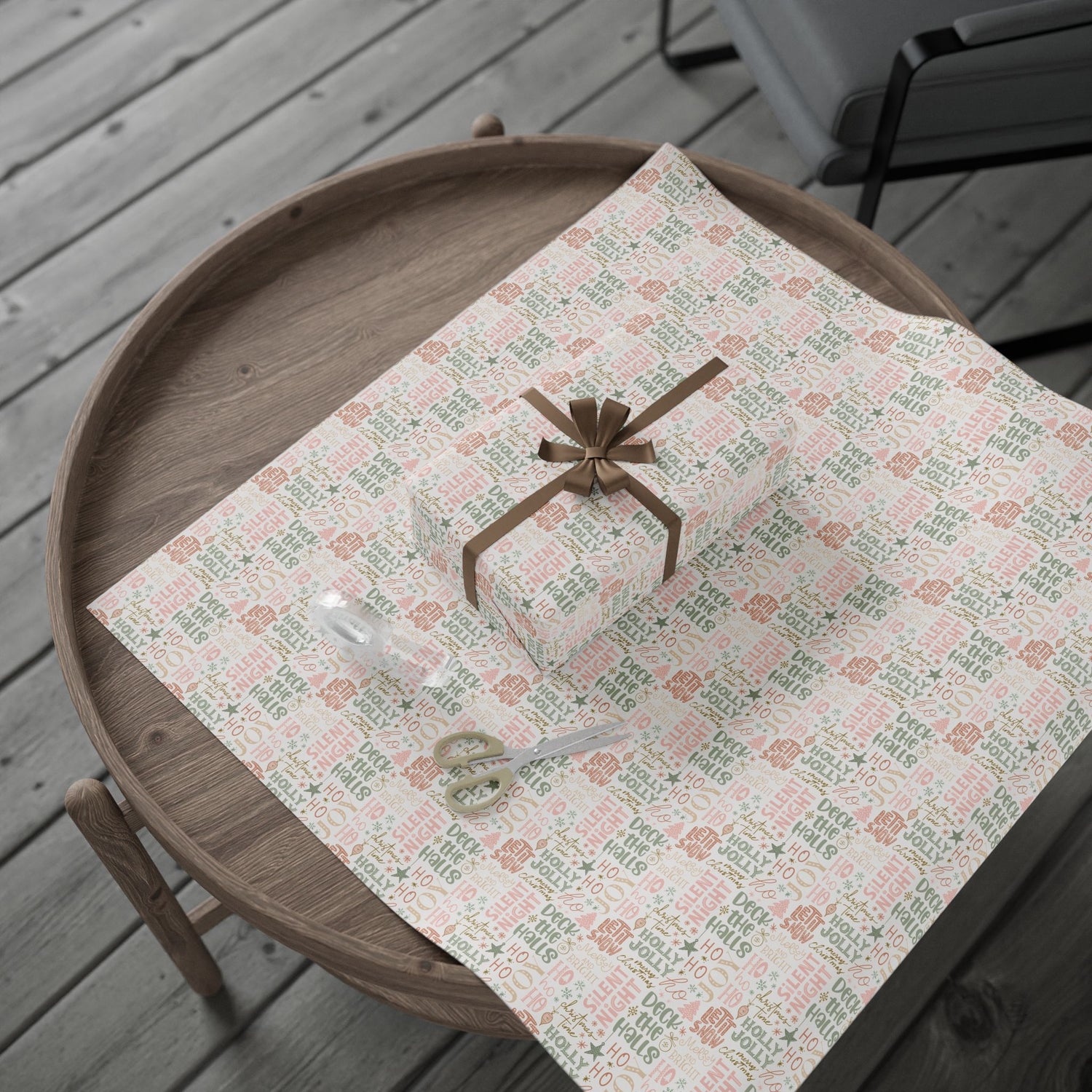 Gift box with a bow on a patterned tablecloth on a wooden table