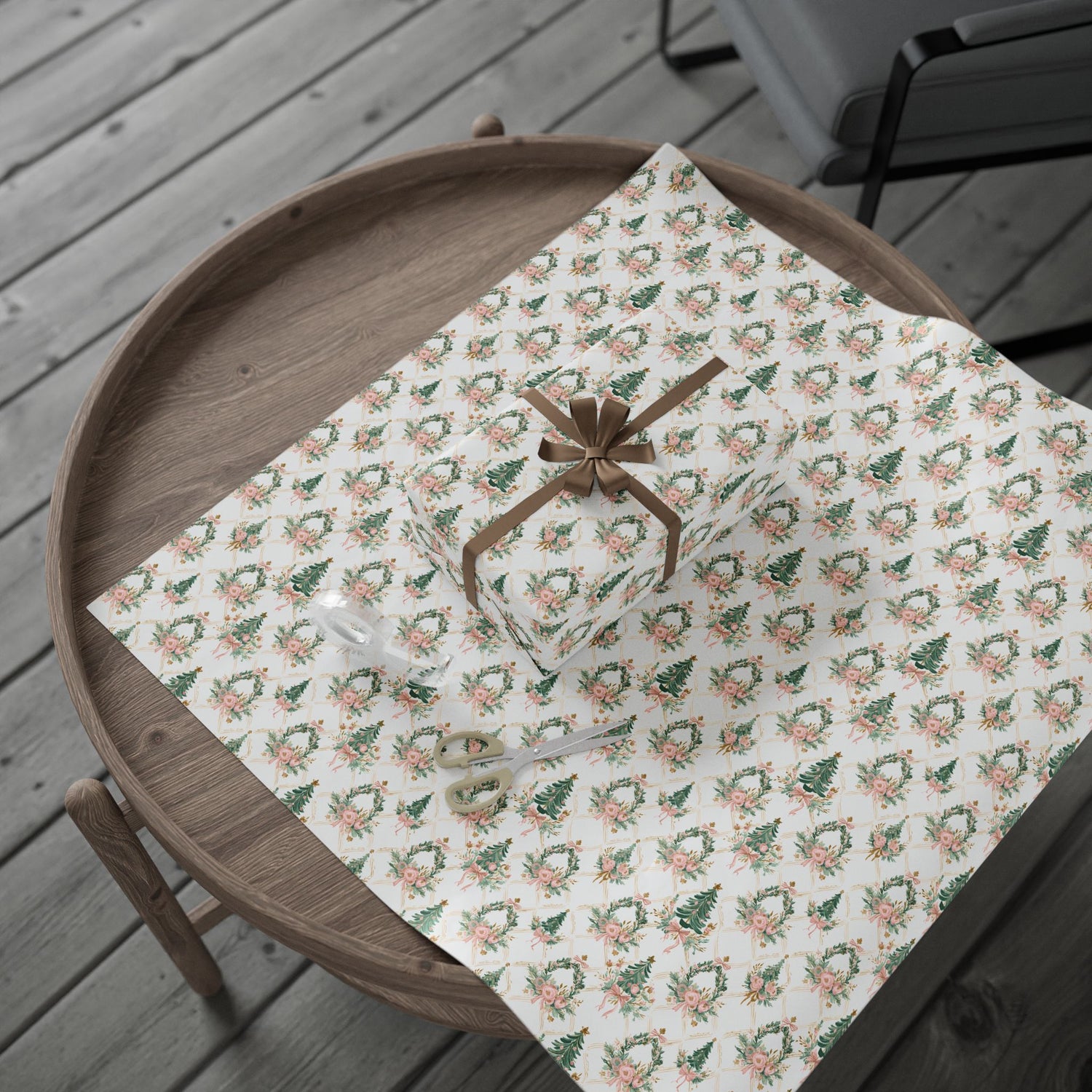 Floral patterned paper with a brown ribbon on a wooden tray