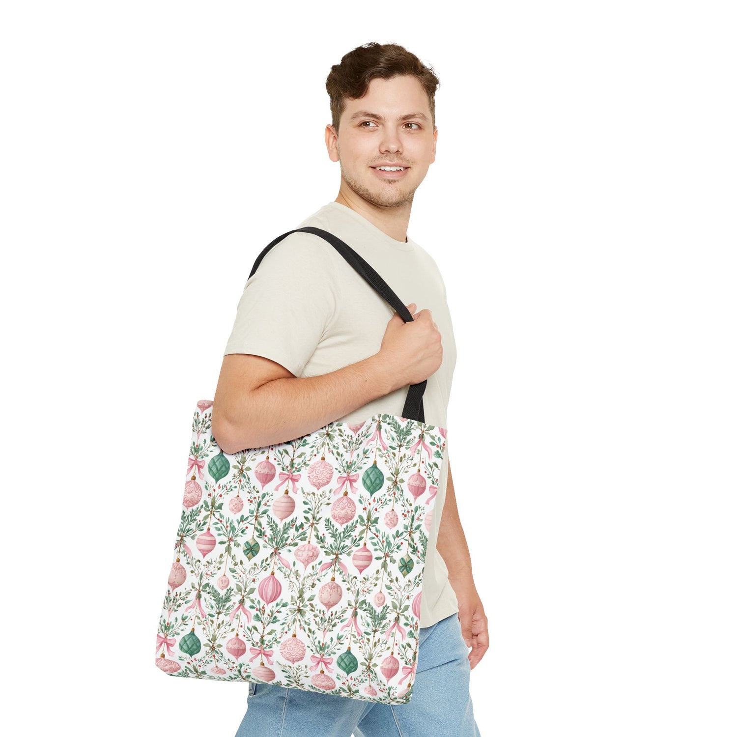 Man holding a floral-patterned tote bag on a white background