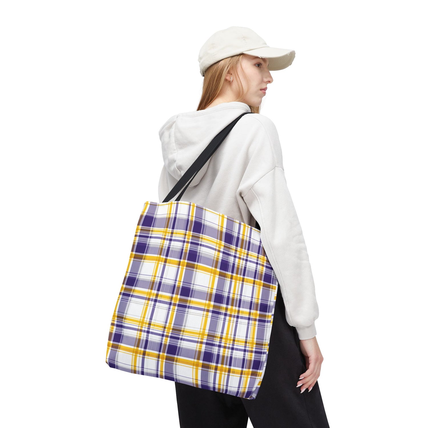 Person wearing a white hoodie and plaid bag on a white background