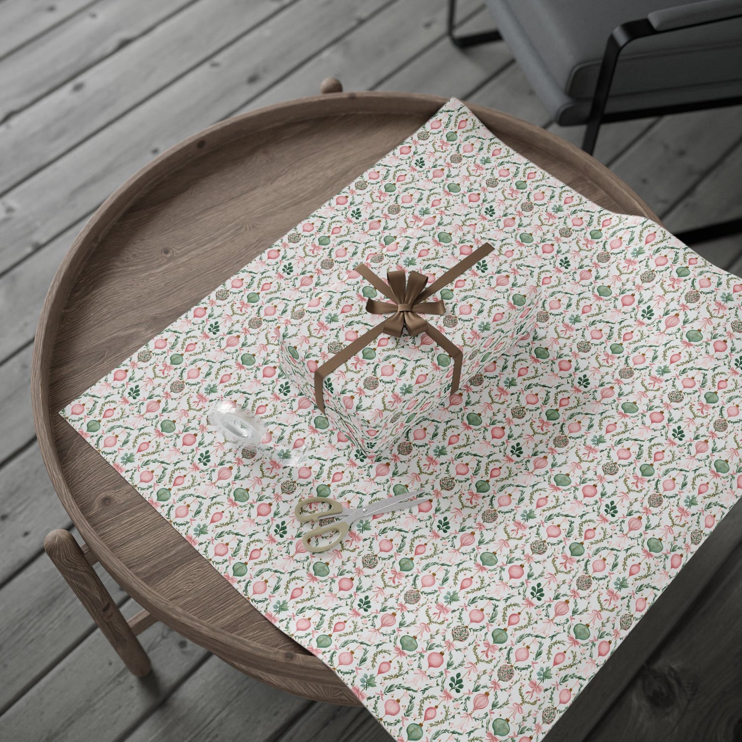 Wooden tray with a floral-patterned cloth and decorative items on a wooden surface.