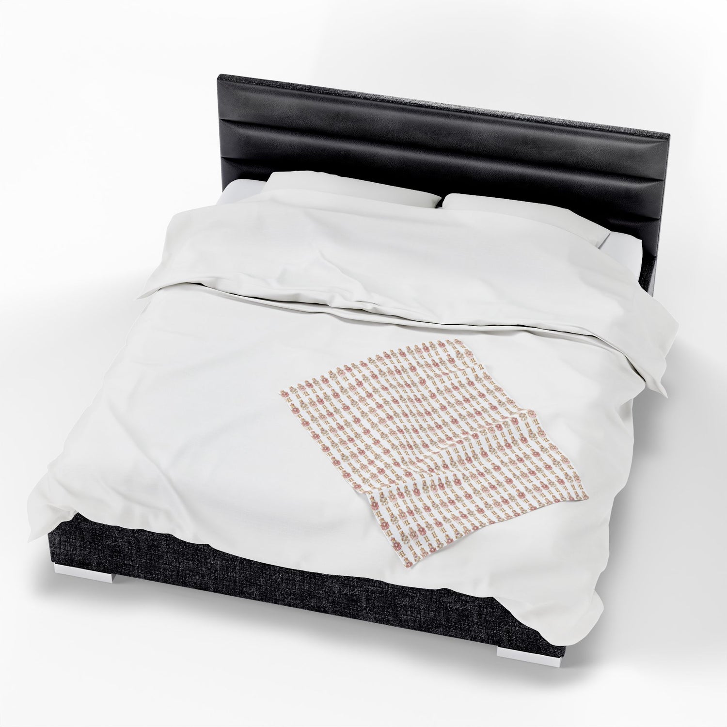 Bed with white bedding and a black headboard on a white background