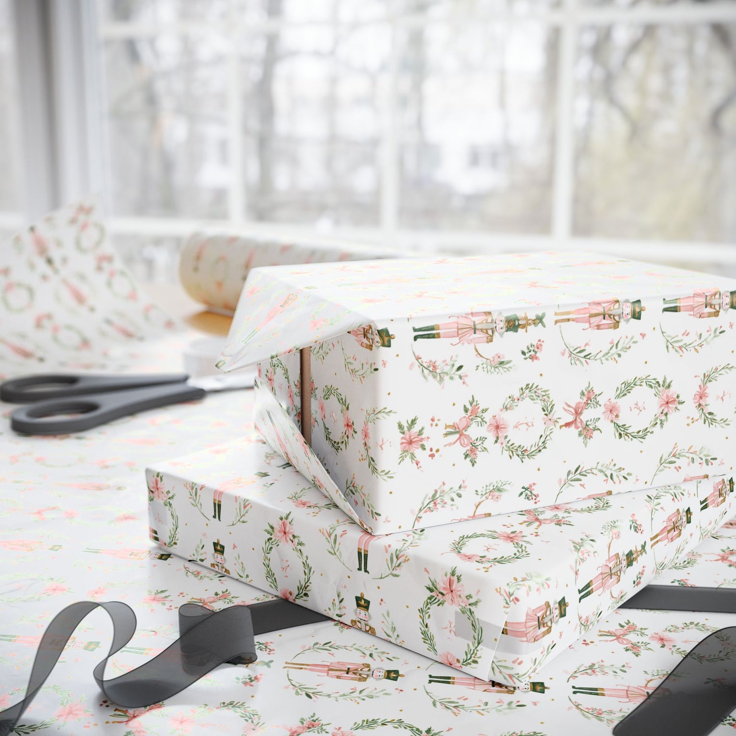 Stack of gift boxes with floral wrapping paper on a light surface.