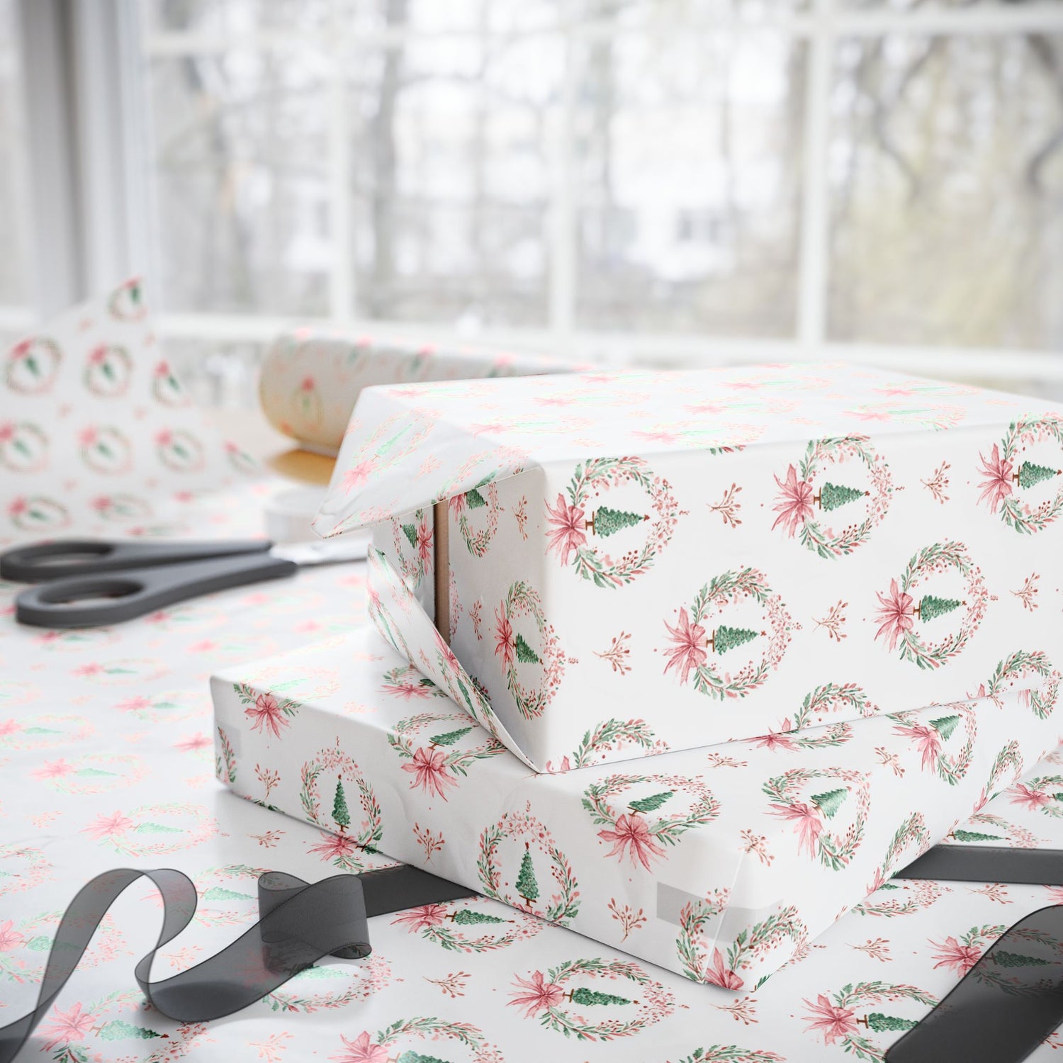 Gift box wrapped in festive paper with floral wreath design on a matching tablecloth.