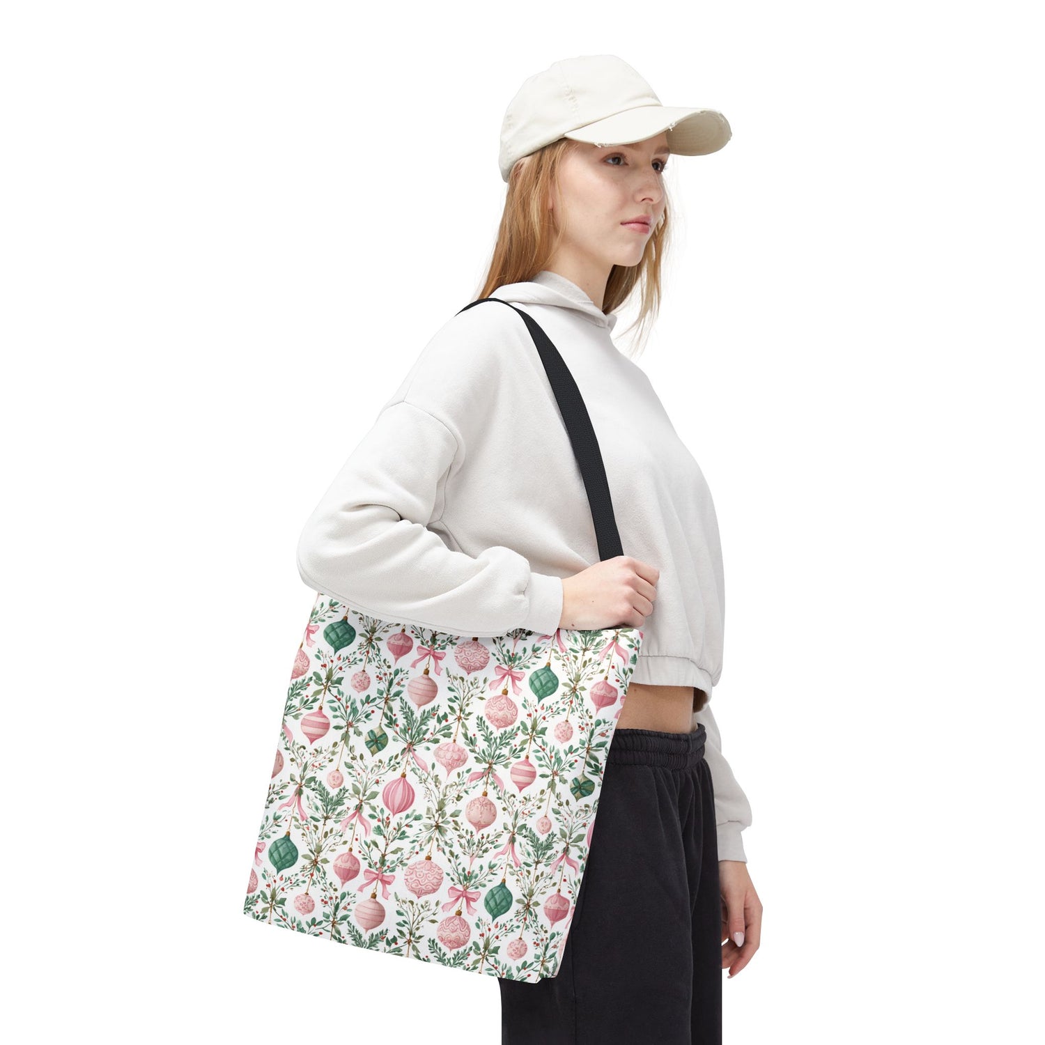 Person holding a floral-patterned bag on a white background