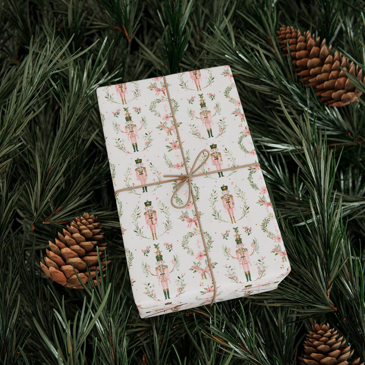 Gift wrapped in festive paper with nutcrackers on a bed of pine needles and pinecones.