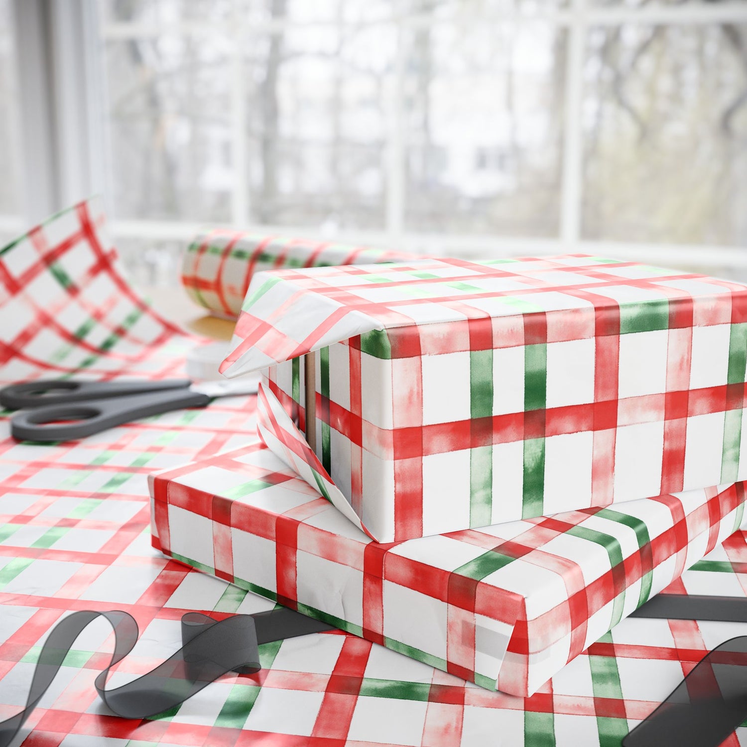 Red and green checkered paper with scissors on a white surface